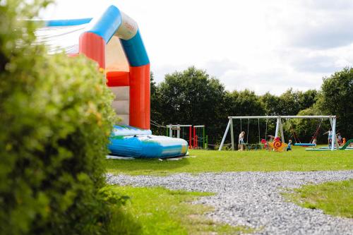 a playground with a slide in a park at Glamping Virton in Virton