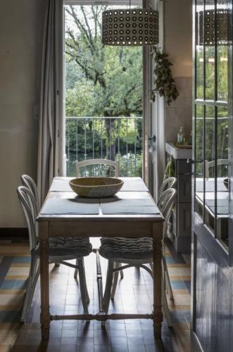 une salle à manger avec une table et des chaises et une fenêtre dans l'établissement Au Bord de la Dronne, à Bonnes