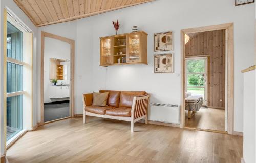 a living room with a couch and a table at Holiday Home Kuskevej Jerup Ix in Jerup