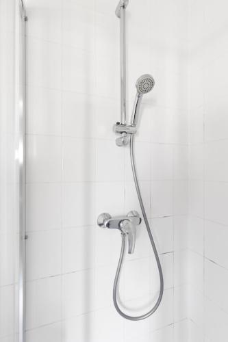 a shower with a shower head in a bathroom at De Lijsterhof in Domburg