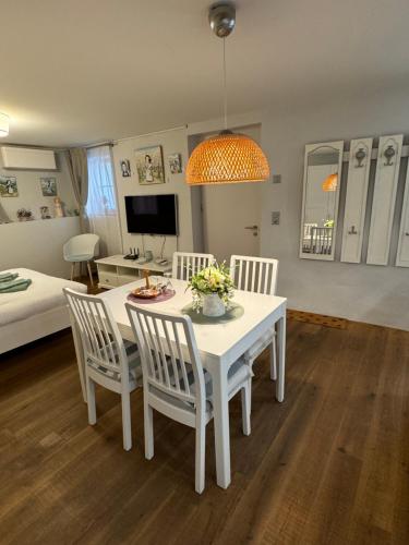 a living room with a white table and chairs at La Lombardie - Charme et tranquillité in Sion