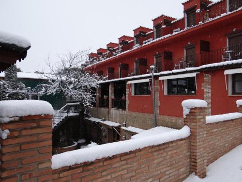 a row of brick buildings with snow on them at Hotel La Rueda 3000 in Mora de Rubielos