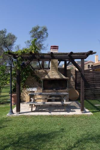 a picnic table and a bench in a park at 5 Stars Villas in Svoronata