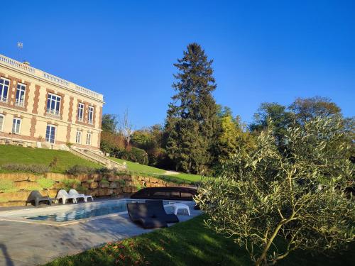 a building with a table and chairs in front of it at Demeure de la Garenne in Montmirail