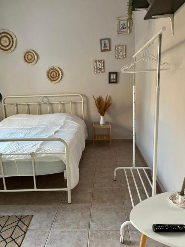 a bedroom with a white bed and a table at DownTown Apartment Konitsa in Konitsa
