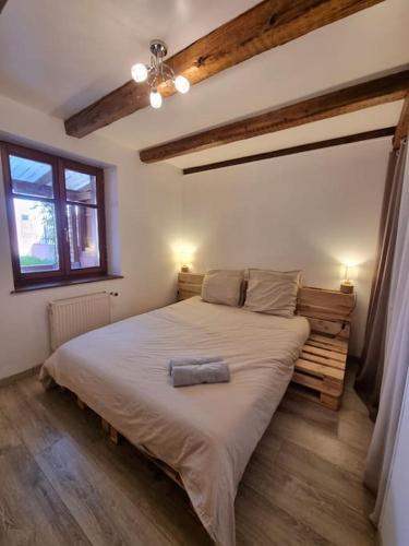 une chambre avec un grand lit dans une pièce dans l'établissement Le Hameau Frontalier, à Buschwiller