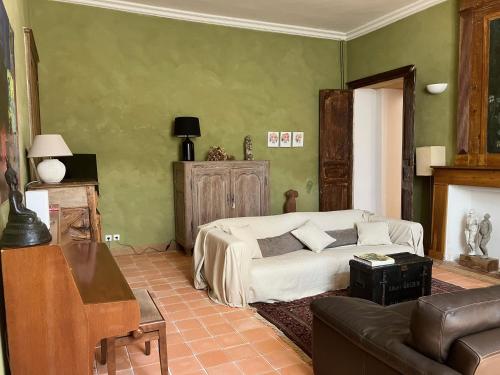 a bedroom with a bed and a couch at Chambres d'hôtes au Château de Gandillac in Saint-Martial-Viveyrol