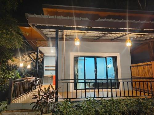 a house with a balcony with a view of the ocean at Ingtara at Lanta in Ko Lanta