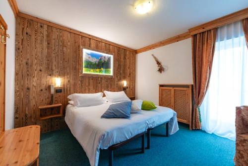 Postel nebo postele na pokoji v ubytování Hotel Ciamol
