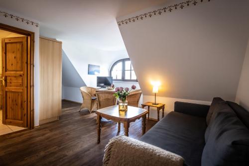 a living room with a couch and a table at Gutshof Bastorf in Kühlungsborn
