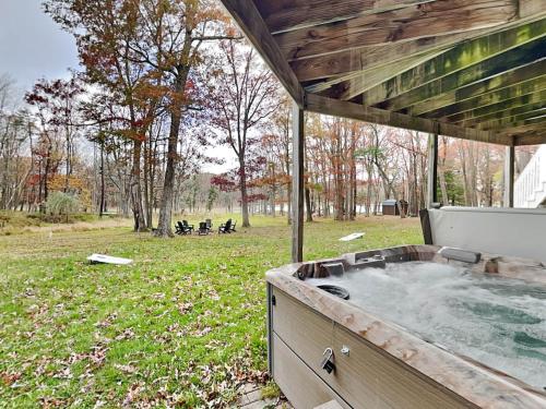 a hot tub in a yard with a field at Starlit Memories in Swanton