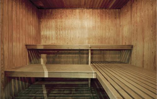 an empty bowling alley with wooden walls and wooden shelves at Stunning Home In Knebel With Sauna in Knebel