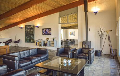 a living room with leather furniture and a fireplace at Stunning Home In Knebel With Sauna in Knebel