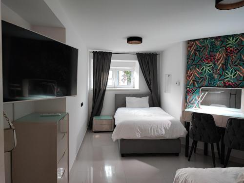 En eller flere senge i et værelse på Engradado Britanski trg