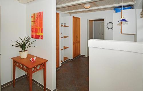a room with a table and a plant on a table at Holiday Home Stakroge - 09 in Knaplund