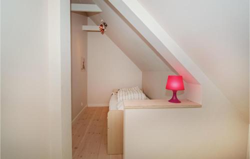 a room with a couch and a red lamp at Holiday Home Stakroge - 09 in Knaplund