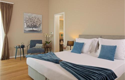 a bedroom with a large bed with blue and white pillows at Villa Vigneto in Brtonigla