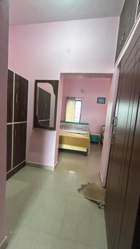 a room with pink walls and a bed in it at Breeze valley Residency in Yelagiri