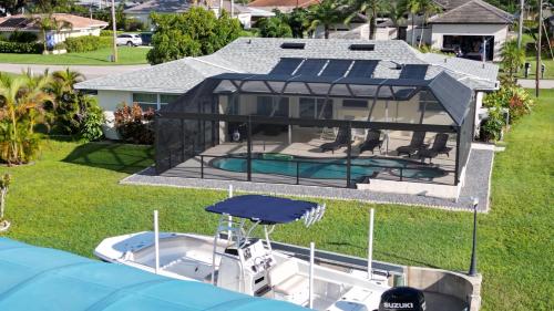 an overhead view of a house with a boat in the yard at Cape Coral villa with a 23ft sportsboat in Cape Coral