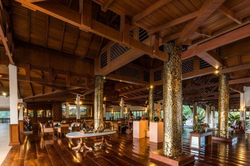 a lobby of a resort with tables and chairs at Andaman Princess Resort & Spa in Ban Pak Ko