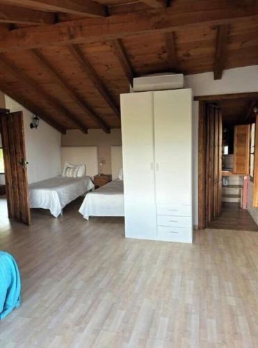 a bedroom with two beds and a white cabinet at El LABRAO DE ALARDOS in El Raso