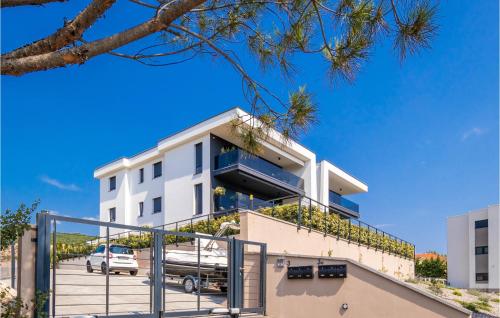 a white apartment building with a parking lot at Nice Apartment In Kostrena With Wifi in Kostrena