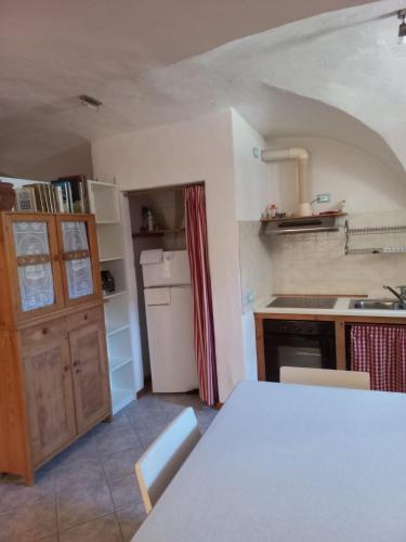 a kitchen with a white table in a room at Ala Roda- appartamento in Ziano di Fiemme