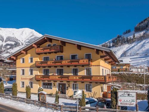 a large yellow building with snow on a mountain at Rainberghof***, Appartements in Rauris