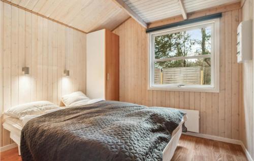a bedroom with a bed and a window at Stunning Home In Fjerritslev With Wifi in Fjerritslev