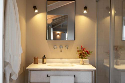 a bathroom with a sink and a mirror at Casa Juanita in Melide