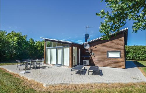 a small cabin with chairs and tables on a patio at Holiday Home Vestervig 44 in Vestervig