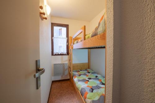 a small room with two bunk beds and a door at Le Village des Thermes in Vignec