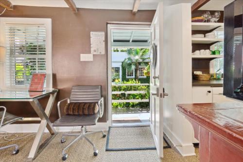 an office with a desk and a chair and a window at 16 E Jones Carriage House in Savannah