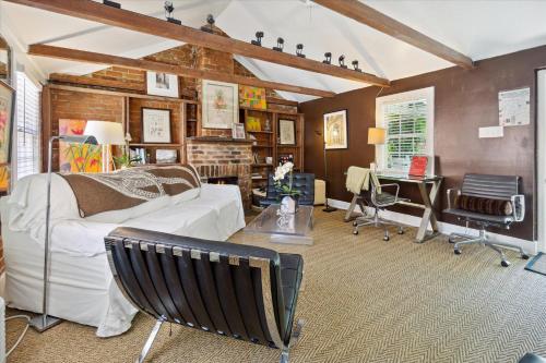 a living room with a white couch and a table at 16 E Jones Carriage House in Savannah