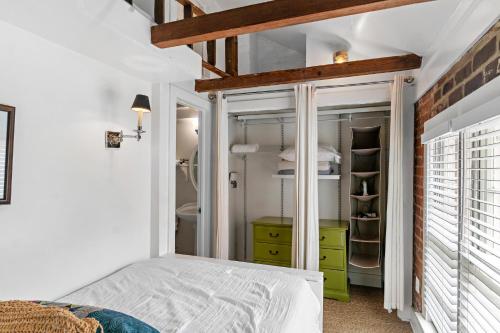 a bedroom with a bed and a green cabinet at 16 E Jones Carriage House in Savannah