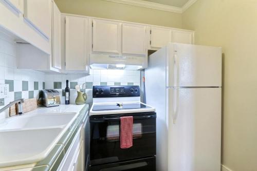 a kitchen with a stove and a refrigerator at 121 W Jones Suite Loft 4f in Savannah