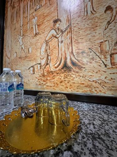 a table with two glasses and water bottles on it at Maxwell inn in Taiping