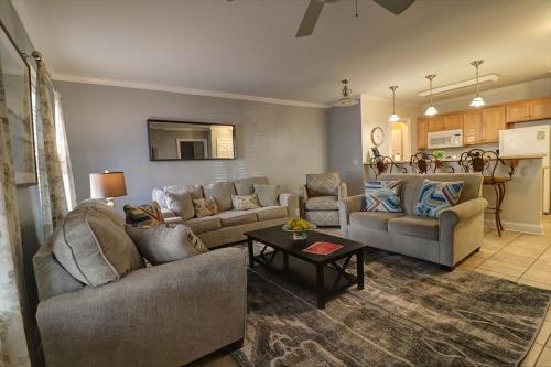 a living room with two couches and a table at 305 W Taylor Garden in Savannah