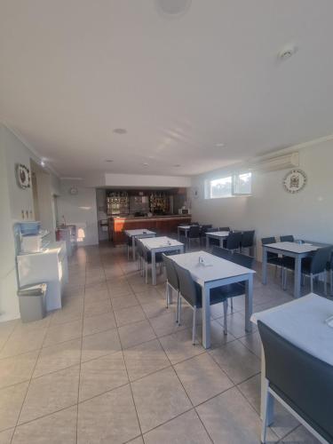 a restaurant with tables and chairs in a room at Hotel Padre Cruz in Valença