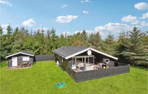 a black house on a green field with trees at 3 Bedroom Awesome Home In Saltum in Saltum
