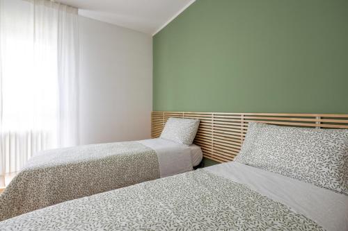a bedroom with two beds and a window at Casa Genny in Padova
