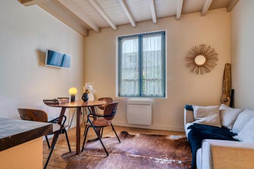 un salon avec une table et un canapé dans l'établissement Le GYPSY - CHARME & EMPLACEMENT PARFAIT, à Honfleur