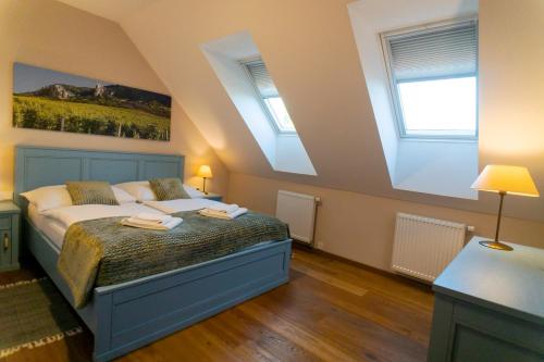 a bedroom with a bed with two towels on it at Vinařství Peřina in Klentnice