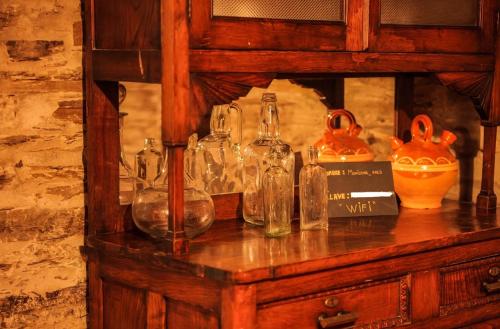 a display of glass bottles and vases on a table at Casa da Rasa in Samos