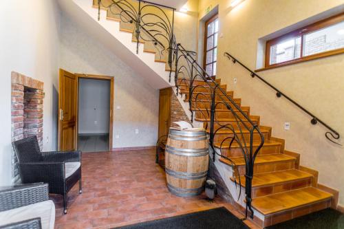a room with a barrel and a staircase with a wine barrel at Vinařství Peřina in Klentnice