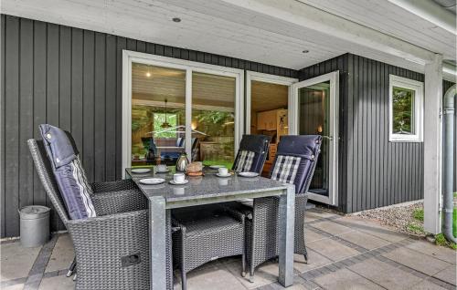 a dining table and chairs on a patio at 3 Bedroom Cozy Home In Herning in Herning