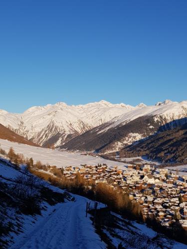 a village in the middle of a snowy mountain at Stall Ferienhaus in Münster