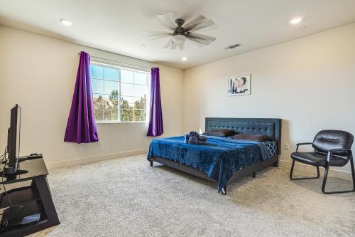 a bedroom with a bed and a chair and a window at 8 Mi to Lincoln Park Family-Friendly Tracy Home in Tracy