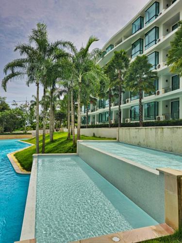 an image of a swimming pool in front of a building at 2 BDR Suite in 5 Star Hotel in Rawai Beach