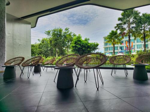 a row of chairs and tables on a patio at 2 BDR Suite in 5 Star Hotel in Rawai Beach